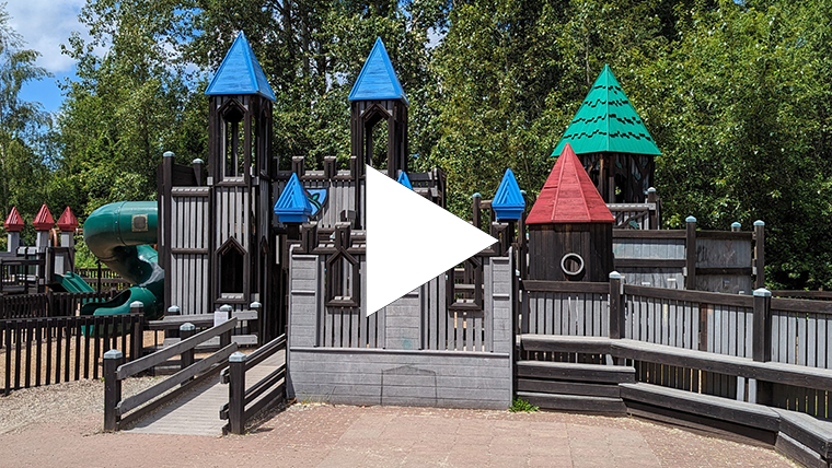 City employee stands in front of the castle playground