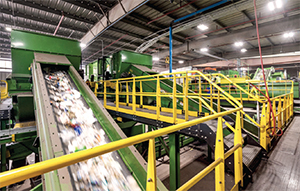 Image shows a conveyor belt inside a WM recycling facility