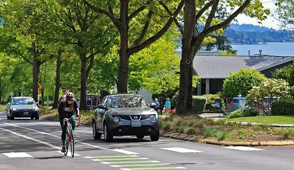 Cyclist biking up Market Street in Kirkland