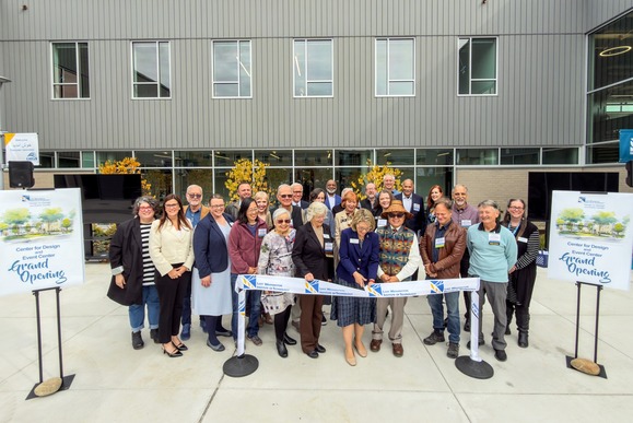 Photo of people in front of a ribbon