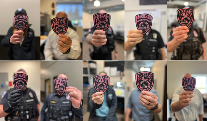 Members of the Kirkland Police department show of pink patches for the month of October