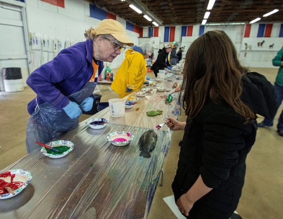 Volunteering helping a child paint