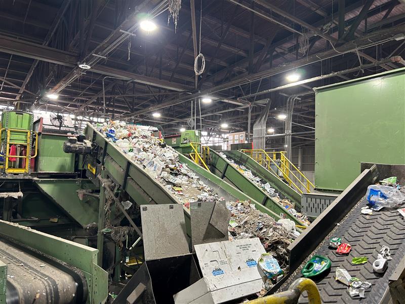 Recycling being pre-sorted on conveyor belts at a material recovery facility. 