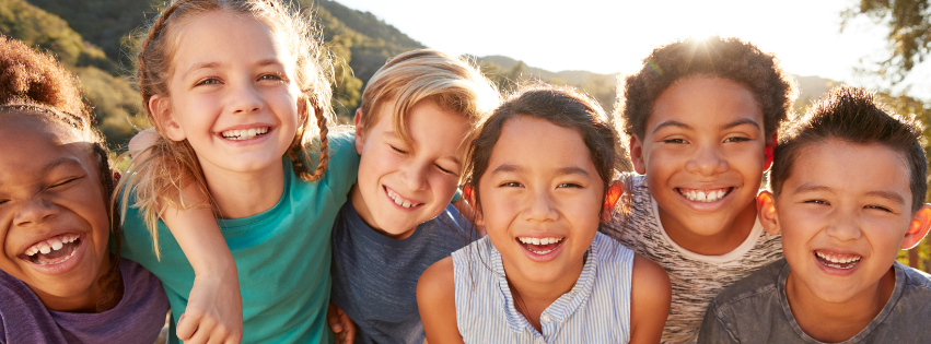 group of diverse children laughing and smiling