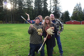 Two award recipients holding a golden litter picker. 