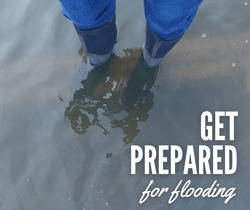 A pair of rain boots standing in water that is about ankle deep