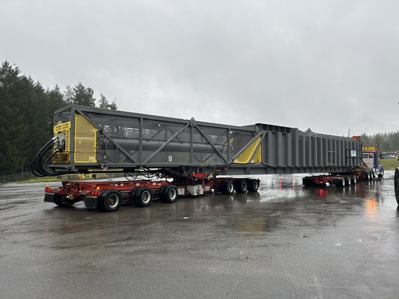 Second compactor on a truck being delivered at Olympic View Transfer Station.