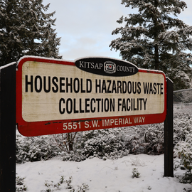 Household Hazardous Waste Collection Facility sign covered in snow.