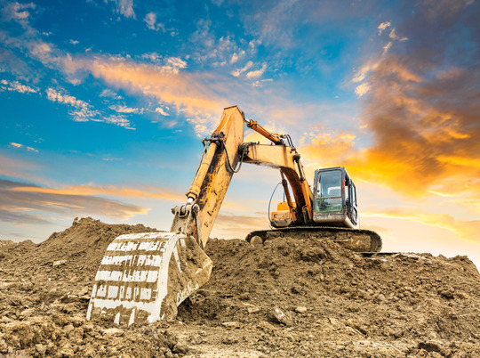 excavator on a pile of dirt