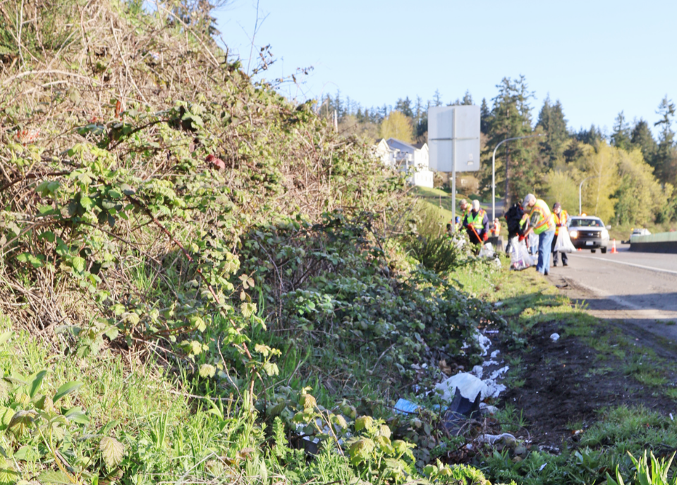 Employees picking up litter along Gorst.