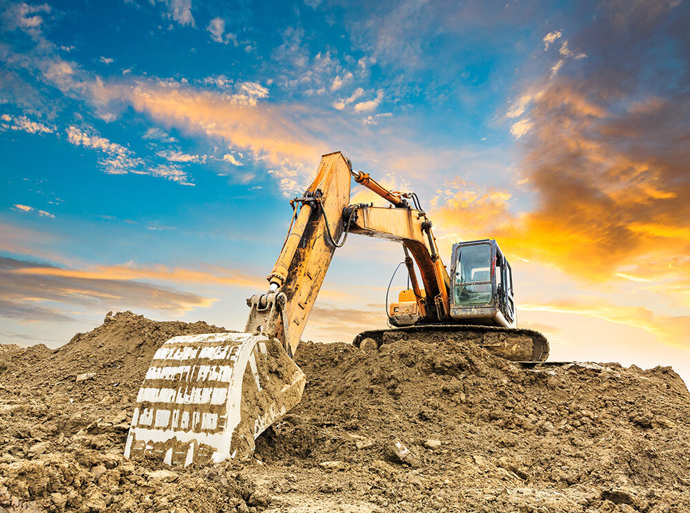 Excavator on a pile of dirt
