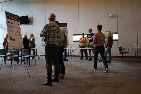 people standing around poster board