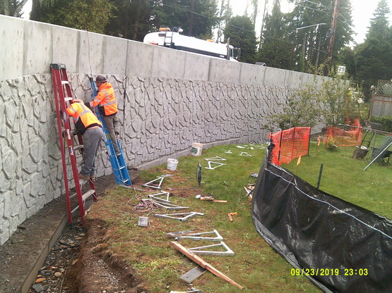 Preparing the retaining wall at the SW quadrant of 172nd and 36th for painting