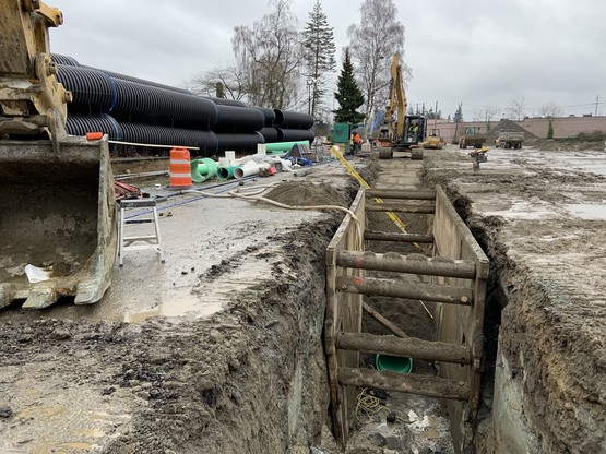 Installing 12 inch gravity sewer pipe, 10 feet underground.