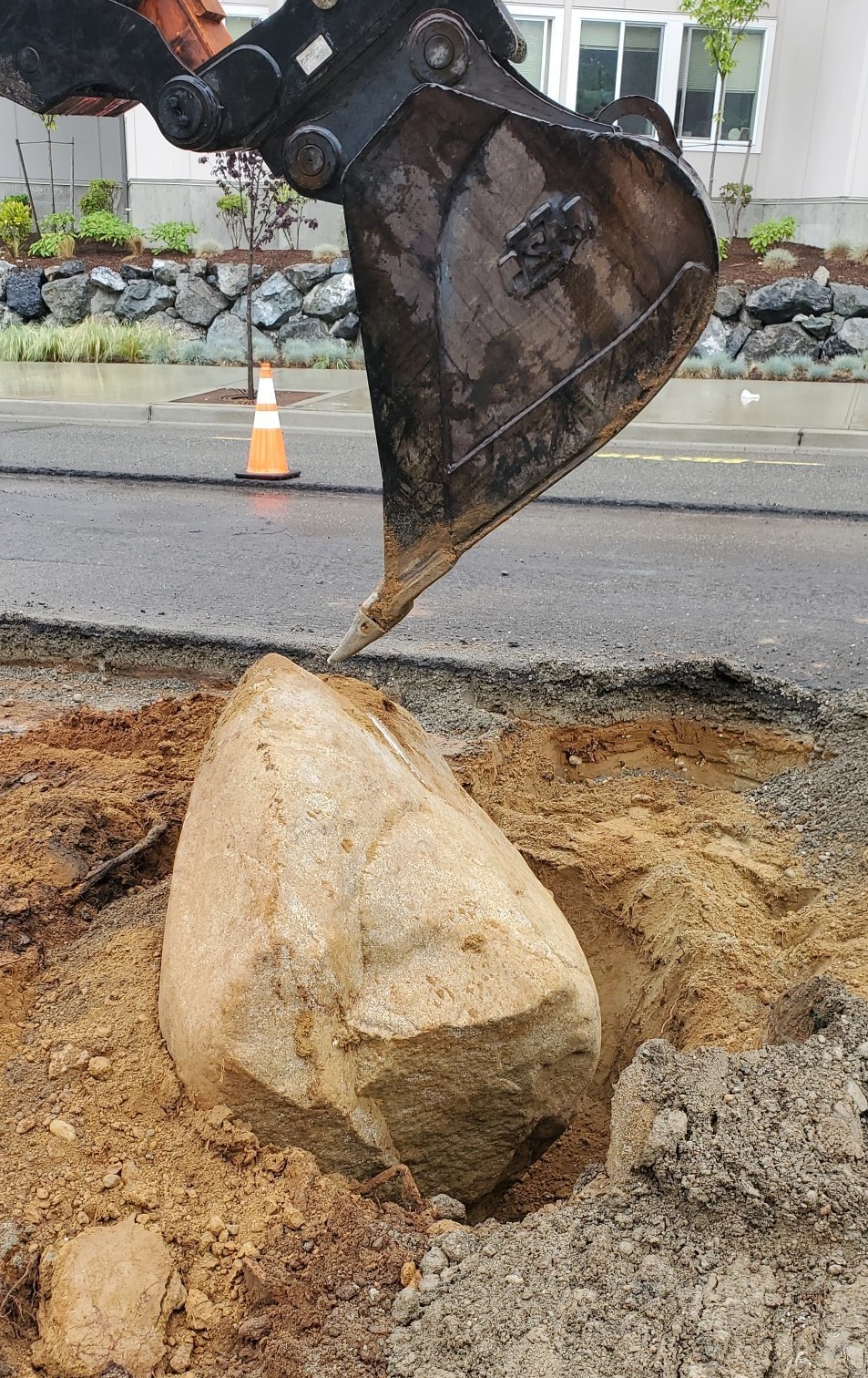 Bolder unearthed on Scriber LK RD. It had to be removed to complete the project correctly.