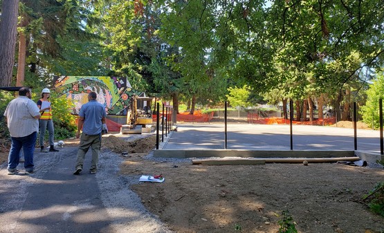 Urban soccer field curb, fence posts, and permeable aggregate base course has been installed.
