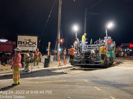 Crews pave the street on the south side of 196th St SW near 44th Ave W