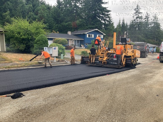 Crews placing asphalt at 60th Ave W and 187th Pl SW