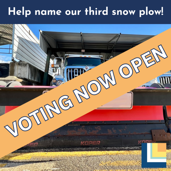 Snow plow with sign that says "voting now open"