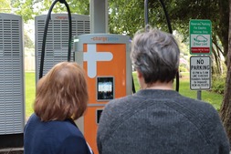 Mayor Christine Frizzell and the first user of the EV charging station
