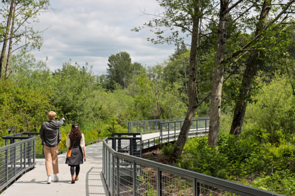 Two people walking along the new boardwalk