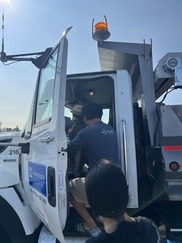 A child inside of one of the City's snowplows
