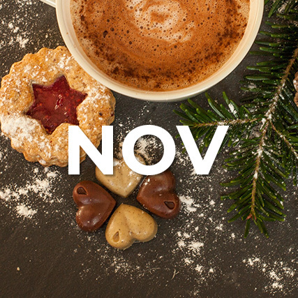 Image of hot cocoa and cookies with text NOV in white
