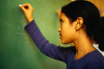 Girl writing on chalkboard