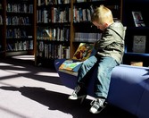 Boy reading in a library