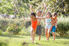 kids playing in sprinkler