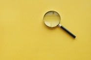 Magnifying glass with yellow background