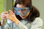 student wearing safety glasses working in a lab