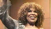 Roberta Flack with hand up