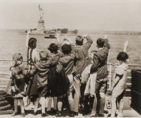 Jewish refugee children wave at the Statue of Liberty as the President Harding steams into New York harbor. Source: USHMM