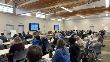 People in a room listening. 