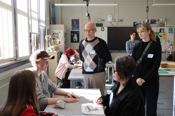 Board and staff speak with students during an art class at Avanti High School