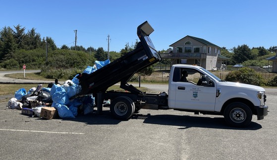 State Parks truck with trailer full of trash at beach