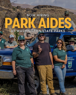 A group of staff stands beside a State Parks work truck.