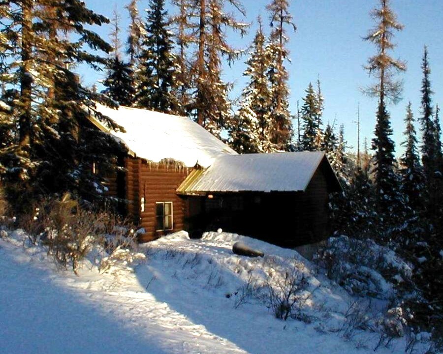 A mountain lodge in the sun and snow.