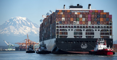 photo of  large container ship arriving at a port