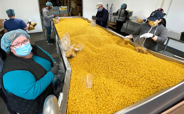 photo of people repacking pasta