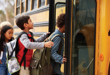 Kids in line at school bus stop
