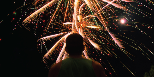 Boy looking up at fireworks display