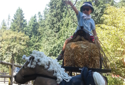 Boy spinning lasso on pretend horse