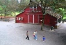 Red Barn with 3 people in front