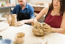 two people working with clay with their hands