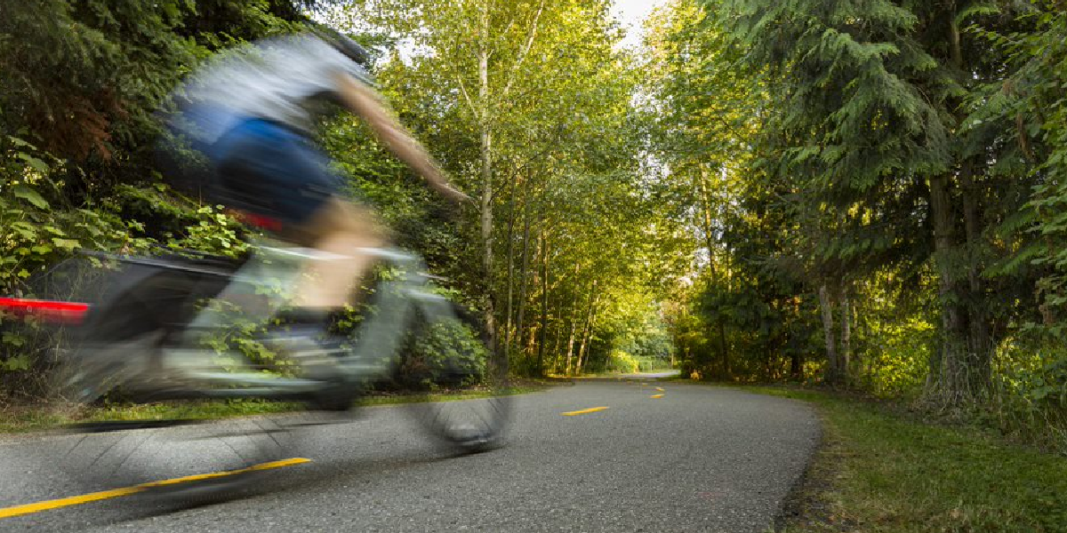 bicyclist riding on trail