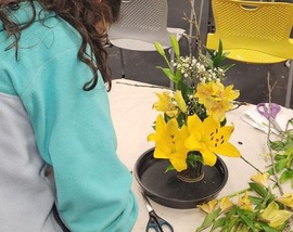 Student arranging flowers