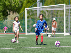 Children playing soccer at Grass Lawn park