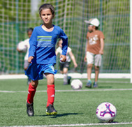 Children playing soccer at Grass Lawn park